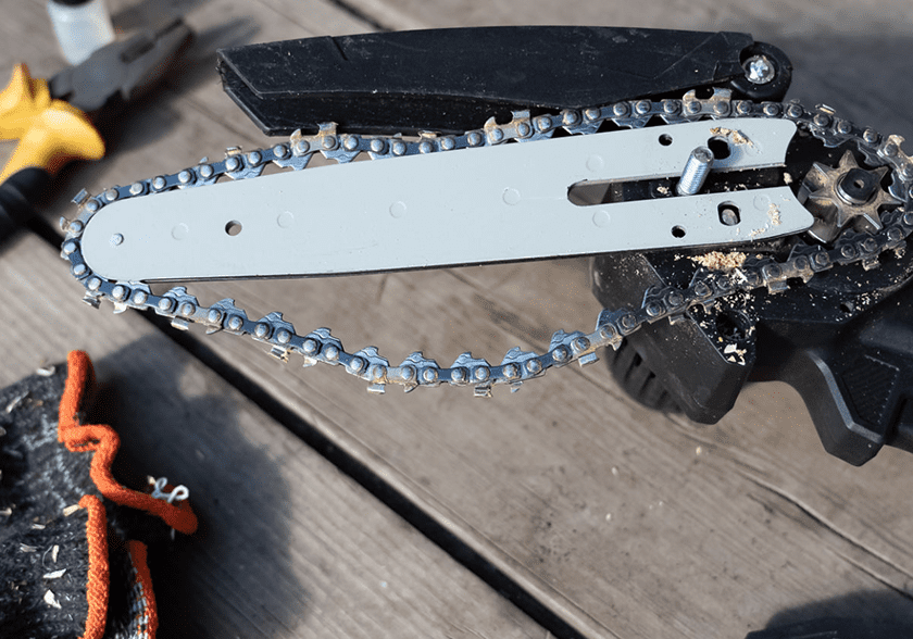 Disassembled chainsaw with chain and tools